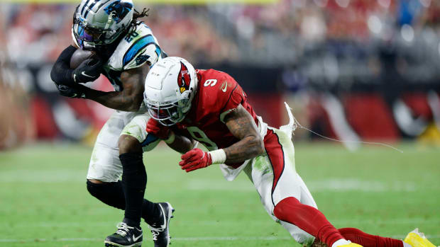 running back Ameer Abdullah runs with the ball in his hands as Arizona Cardinals linebacker Isaiah Simmons leans to tackle him